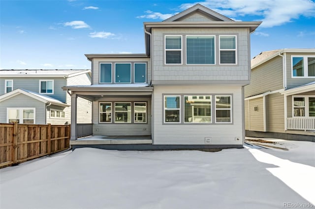 rear view of property featuring a patio and fence