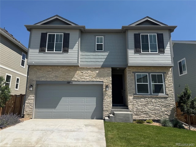 16651 W 93rd Ave, Arvada, CO 80007 - view of front of property with stone siding, a garage, and concrete driveway