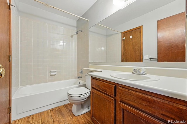 full bathroom with toilet, vanity, wood finished floors, and shower / bathtub combination