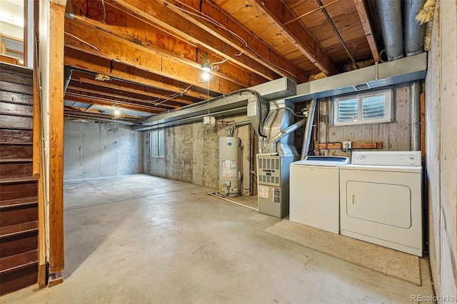basement with stairway, water heater, washing machine and clothes dryer, and heating unit