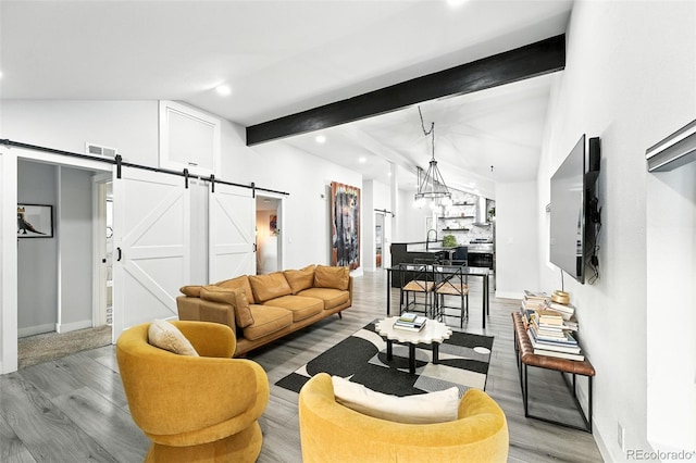 2500 Estes St, Lakewood, CO 80215 - living room with a barn door, wood finished floors, and recessed lighting