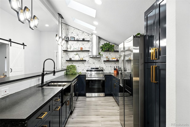 2500 Estes St, Lakewood, CO 80215 - kitchen featuring appliances with stainless steel finishes, open shelves, dark countertops, extractor fan, and light wood-style floors