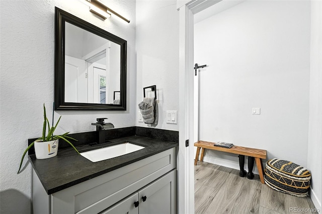 2500 Estes St, Lakewood, CO 80215 - bathroom with wood finished floors and vanity