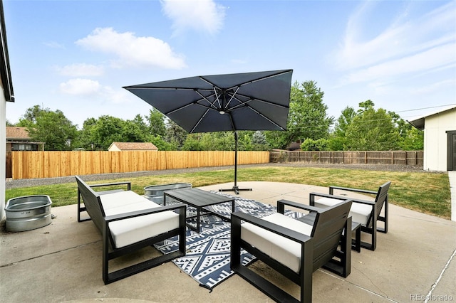 2500 Estes St, Lakewood, CO 80215 - fenced backyard featuring a patio and an outdoor living space with a fire pit