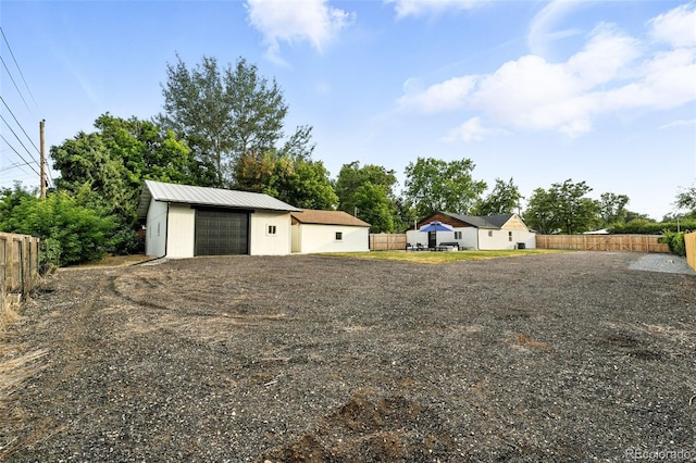 2500 Estes St, Lakewood, CO 80215 - view of yard with a detached garage, an outbuilding, and driveway