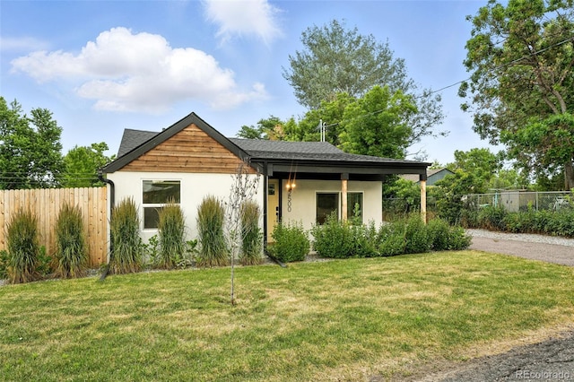 2500 Estes St, Lakewood, CO 80215 - view of front of house with stucco siding and gravel driveway