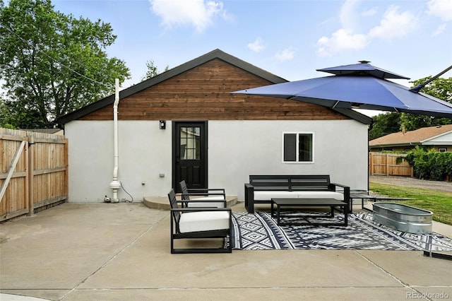 2500 Estes St, Lakewood, CO 80215 - rear view of property with a patio, stucco siding, entry steps, and an outdoor hangout area