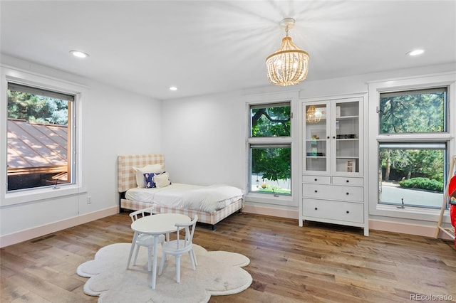 bedroom with multiple windows, baseboards, wood finished floors, and recessed lighting