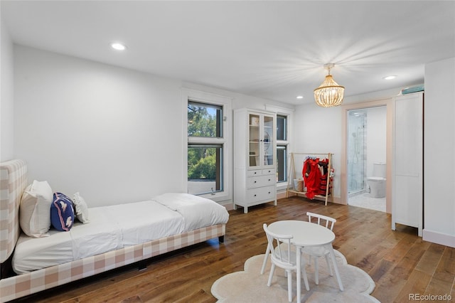 bedroom with a chandelier, dark wood finished floors, connected bathroom, and recessed lighting