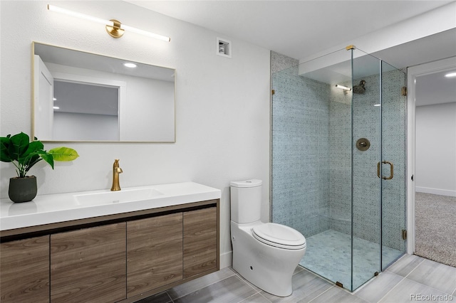 full bath with a stall shower, visible vents, vanity, and toilet