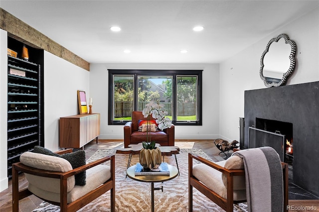 living area with baseboards, a high end fireplace, and recessed lighting