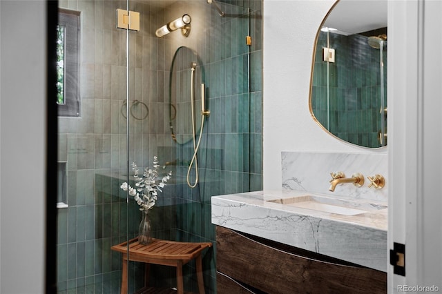 bathroom featuring a walk in shower and vanity