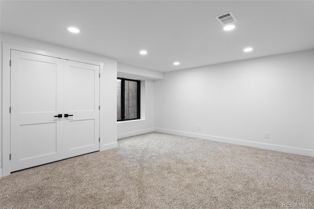 empty room featuring recessed lighting, baseboards, visible vents, and carpet flooring