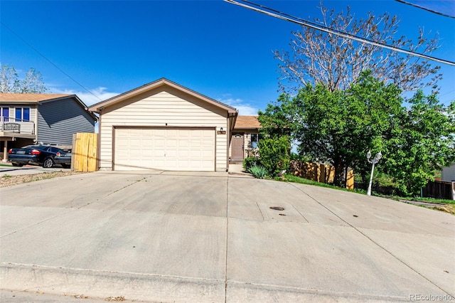 3296 S Bryant St, Englewood, CO 80110 - ranch-style house with concrete driveway, fence, and a garage