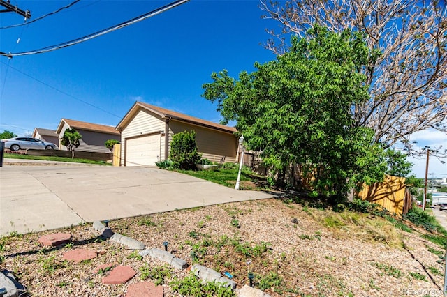 3296 S Bryant St, Englewood, CO 80110 - view of home's exterior with fence, an outbuilding, and a garage