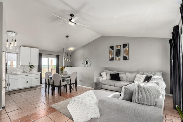 3296 S Bryant St, Englewood, CO 80110 - living room with vaulted ceiling, a ceiling fan, light tile patterned floors, and baseboards