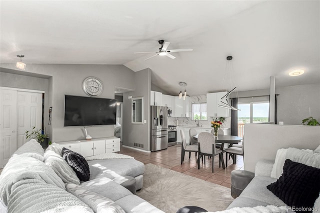 3296 S Bryant St, Englewood, CO 80110 - living room with light tile patterned floors, ceiling fan, and lofted ceiling