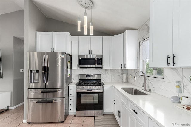 3296 S Bryant St, Englewood, CO 80110 - kitchen with appliances with stainless steel finishes, a sink, lofted ceiling, light countertops, and white cabinetry