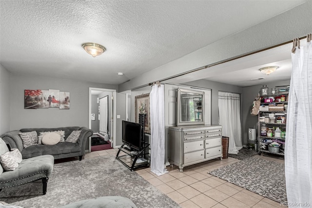 3296 S Bryant St, Englewood, CO 80110 - living room with light tile patterned floors and a textured ceiling