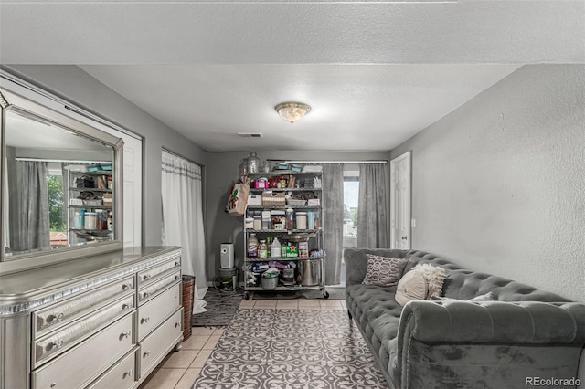 3296 S Bryant St, Englewood, CO 80110 - sitting room featuring light tile patterned floors, plenty of natural light, and a textured ceiling