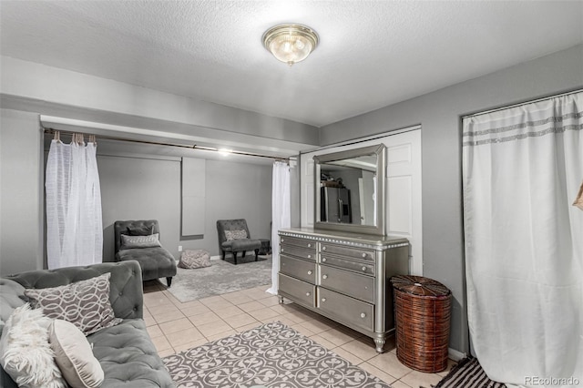3296 S Bryant St, Englewood, CO 80110 - bedroom with light tile patterned floors and a textured ceiling