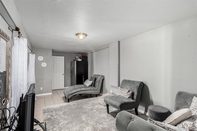 3296 S Bryant St, Englewood, CO 80110 - living area featuring a textured ceiling, light tile patterned flooring, and baseboards