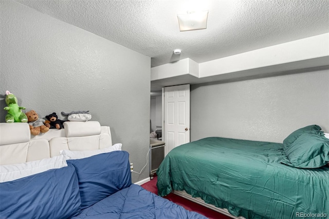 3296 S Bryant St, Englewood, CO 80110 - bedroom featuring a textured wall, a textured ceiling, baseboards, and carpet flooring