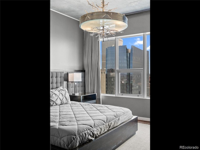 891 14th St Unit 3410, Denver, CO 80202 - bedroom featuring crown molding and a chandelier
