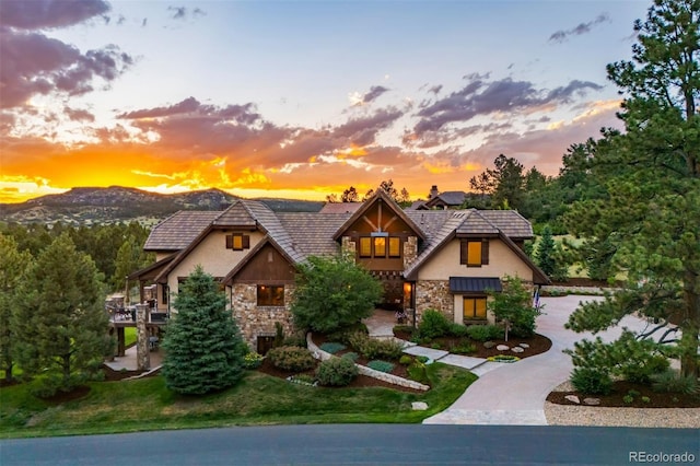 tudor house featuring a lawn and a mountain view