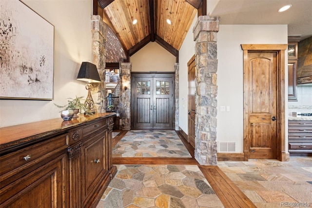 entrance foyer with wood ceiling, high vaulted ceiling, and french doors