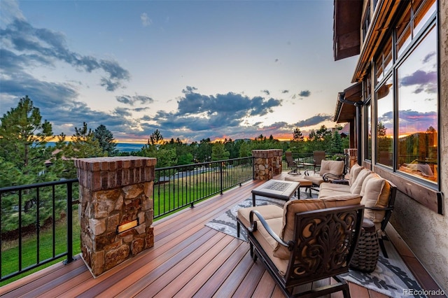 deck at dusk with an outdoor hangout area