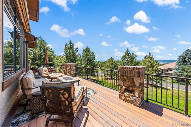 wooden deck with an outdoor fire pit