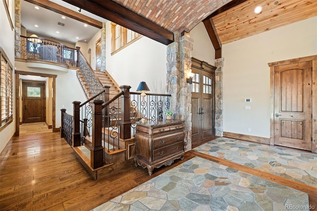 entrance foyer featuring hardwood / wood-style floors, high vaulted ceiling, and a wealth of natural light