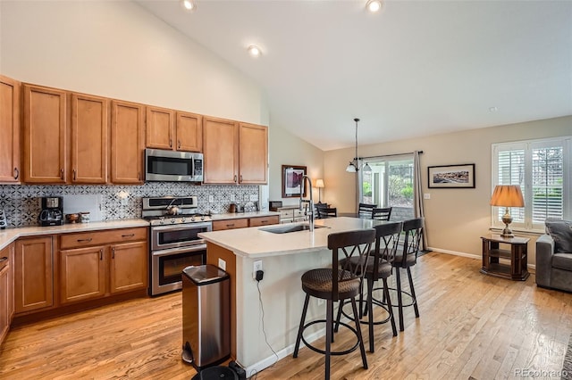 23808 E Bellewood Dr, Aurora, CO 80016 - kitchen featuring stainless steel appliances, light wood-type flooring, brown cabinetry, light countertops, and backsplash