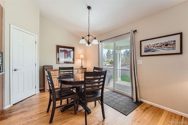 23808 E Bellewood Dr, Aurora, CO 80016 - dining space featuring a chandelier, light wood-style floors, and vaulted ceiling