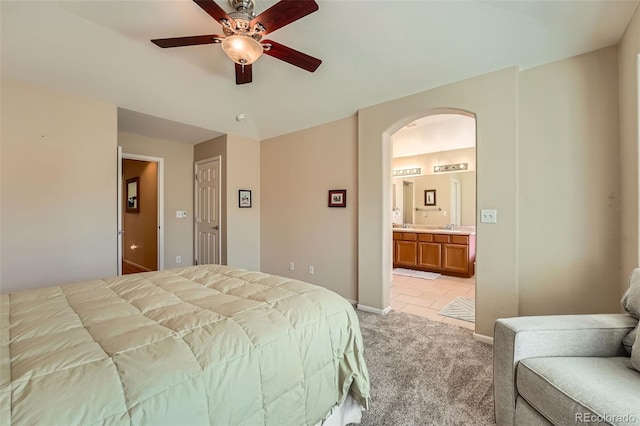 23808 E Bellewood Dr, Aurora, CO 80016 - bedroom featuring arched walkways, light colored carpet, connected bathroom, light tile patterned floors, and ceiling fan