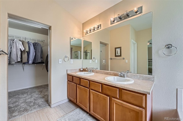 23808 E Bellewood Dr, Aurora, CO 80016 - full bathroom featuring double vanity and a spacious closet