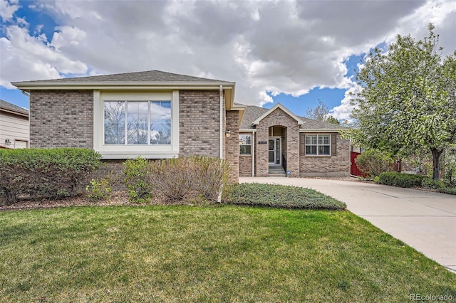 23808 E Bellewood Dr, Aurora, CO 80016 - view of front of home with brick siding, a front yard, and driveway
