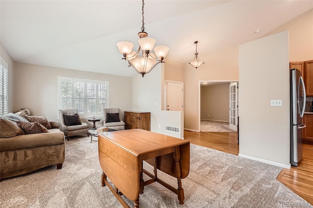 23808 E Bellewood Dr, Aurora, CO 80016 - living room with a chandelier, lofted ceiling, light wood-style flooring, and light carpet