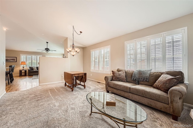 23808 E Bellewood Dr, Aurora, CO 80016 - living area featuring light colored carpet, lofted ceiling, a ceiling fan, and a chandelier
