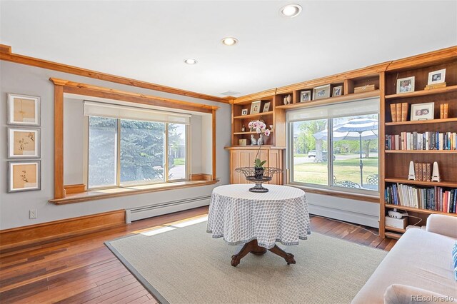 1100 Pontiac St, Denver, CO 80220 - living area featuring a baseboard heating unit, healthy amount of natural light, wood-type flooring, crown molding, and recessed lighting