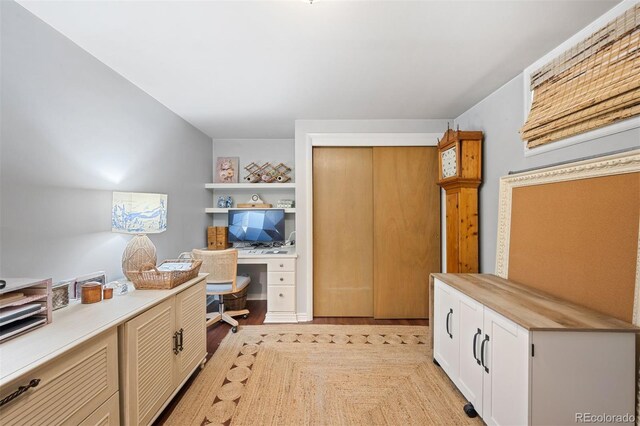 1100 Pontiac St, Denver, CO 80220 - home office featuring built in desk and light wood-style floors