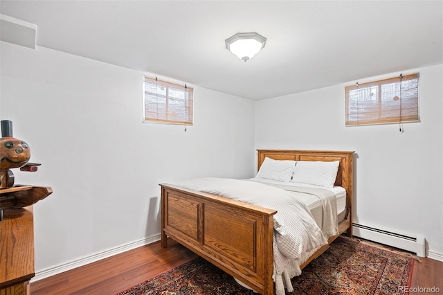 1100 Pontiac St, Denver, CO 80220 - bedroom featuring a baseboard radiator, wood finished floors, and baseboards
