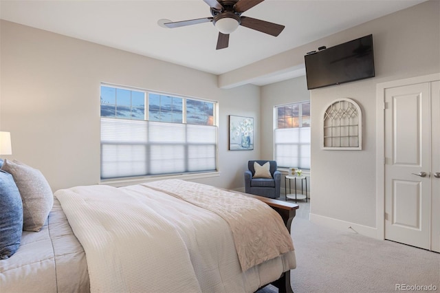 bedroom featuring baseboards, light carpet, and ceiling fan