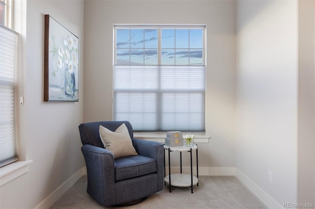 sitting room with baseboards and carpet flooring