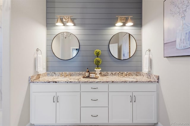bathroom featuring a sink and double vanity