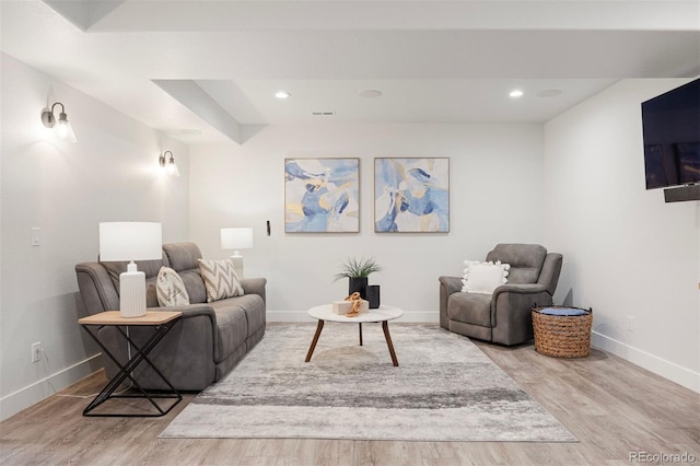 living area featuring baseboards, recessed lighting, wood finished floors, and visible vents