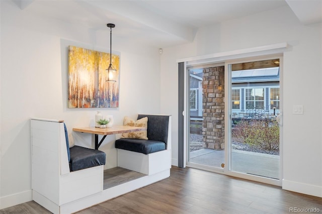 dining area with baseboards, wood finished floors, and breakfast area