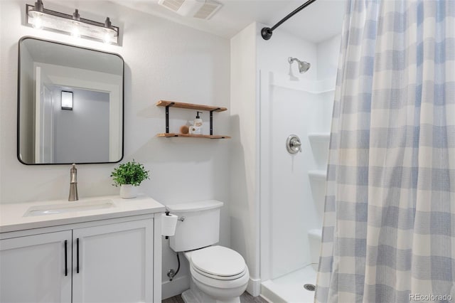 bathroom featuring visible vents, vanity, toilet, and a shower stall