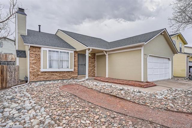 ranch-style house with brick siding, a chimney, an attached garage, fence, and driveway